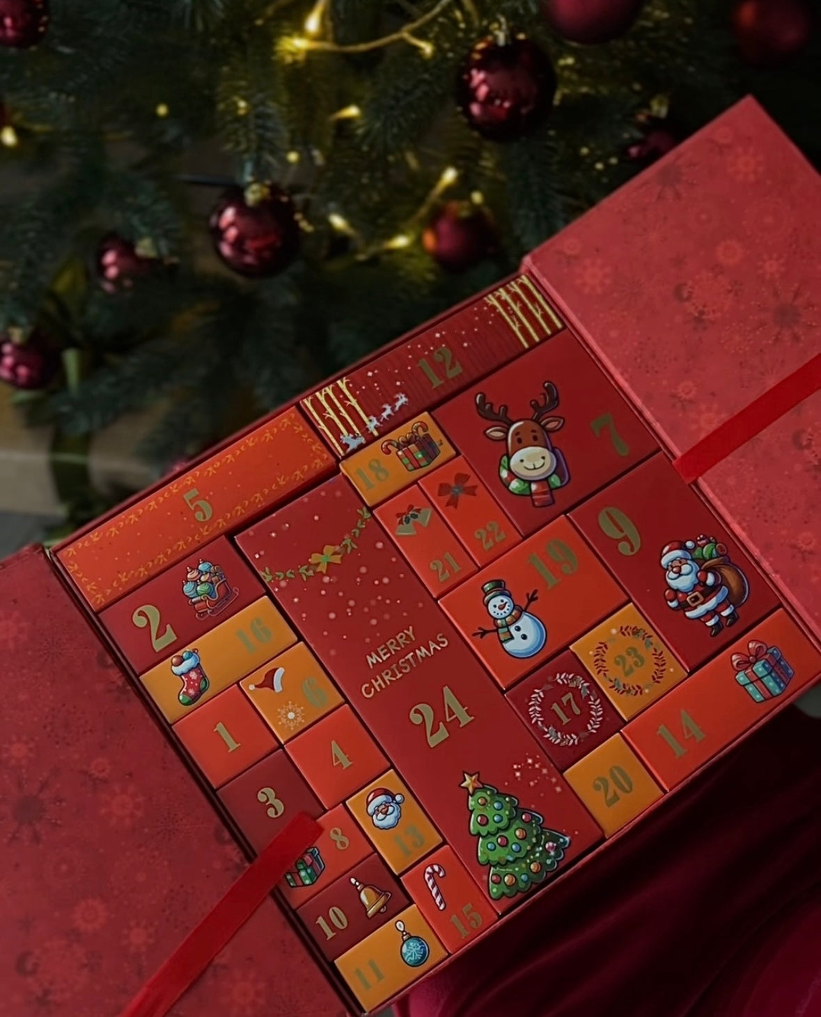 Red Christmas beauty advent calendar with 24 numbered boxes and festive design, part of Beauté Magasin 2025 collection.